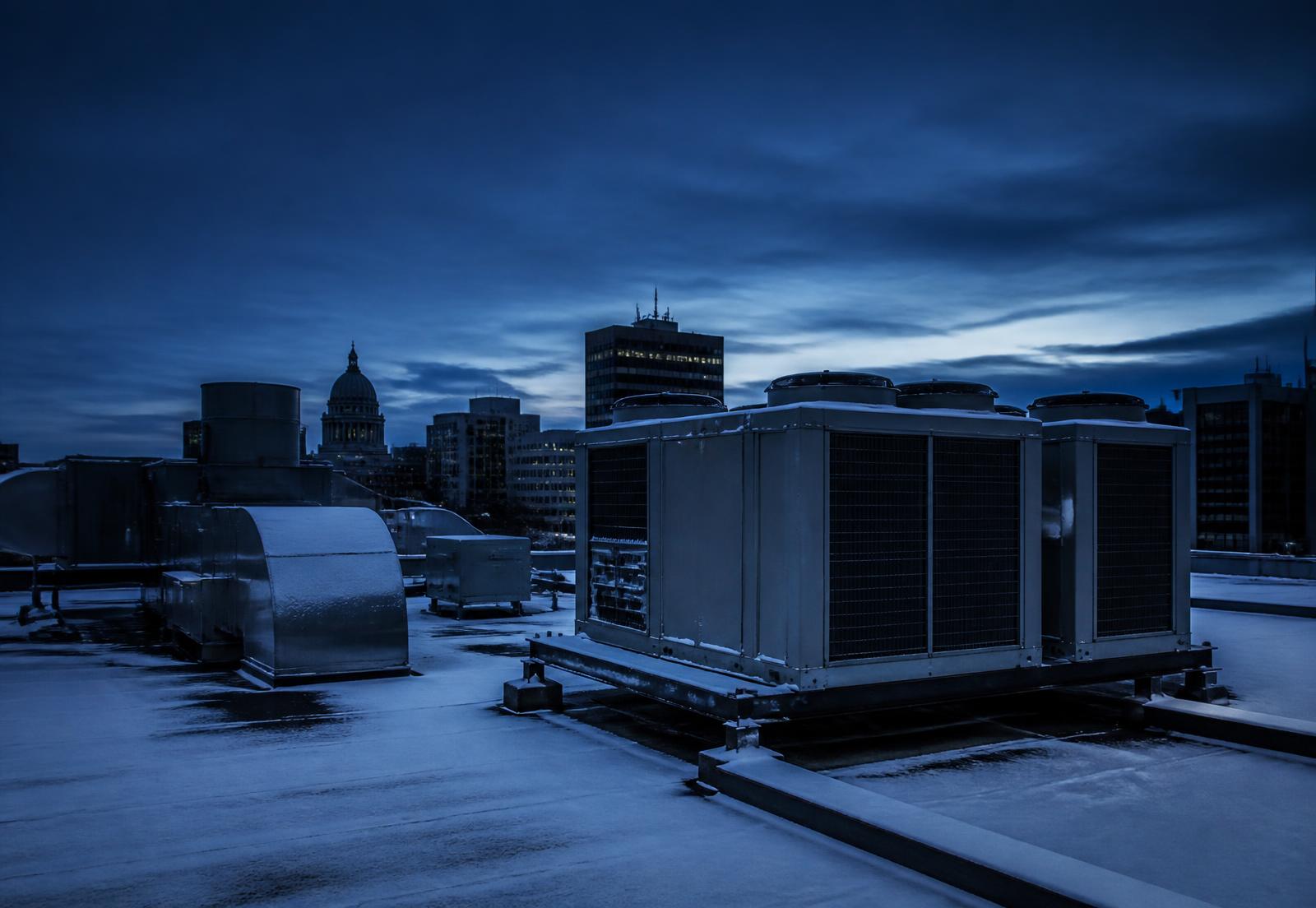Commercial rooftop HVAC and refrigeration units in Winnipeg at dusk